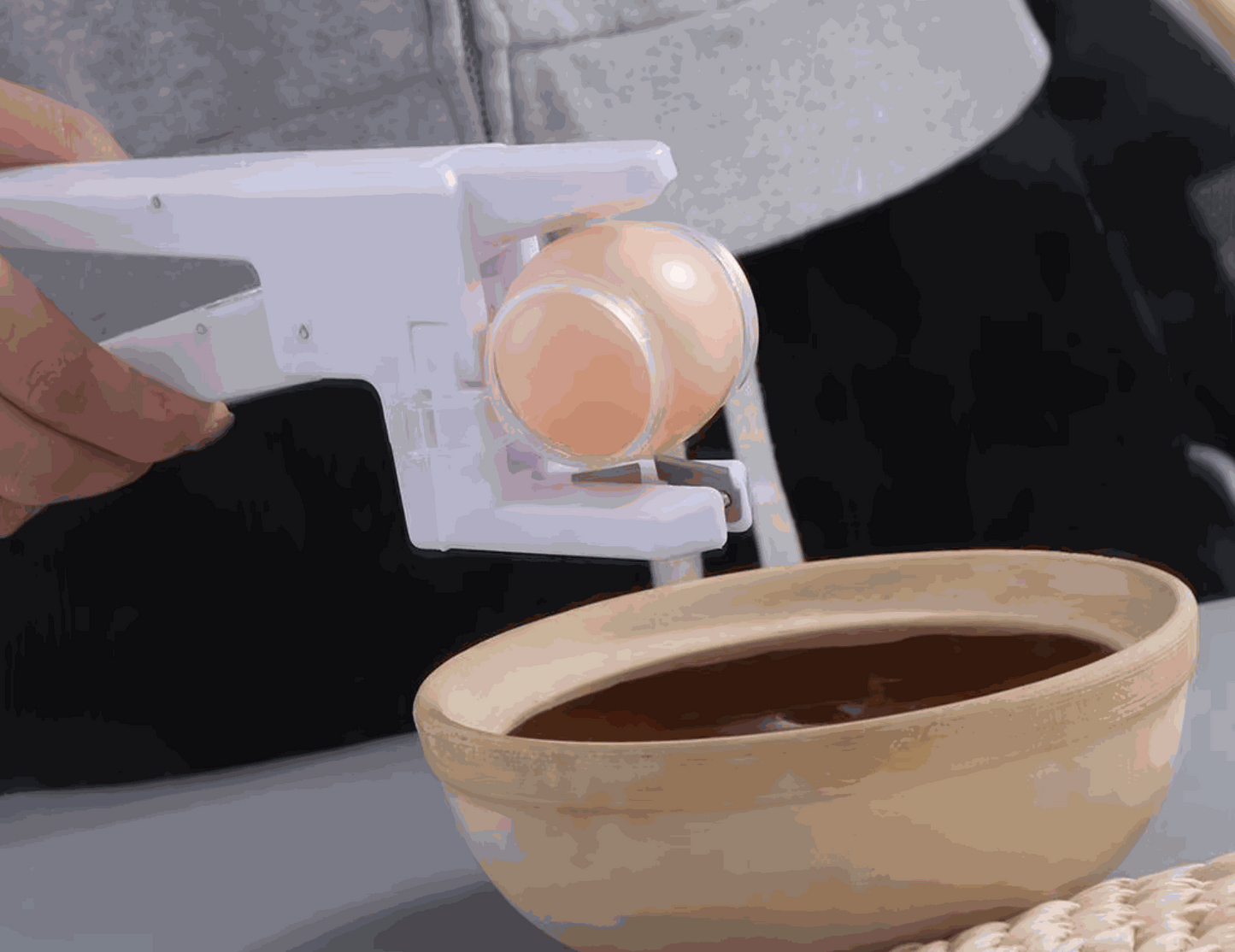 Claver Crack mess-minimizing egg cracker tool in kitchen
